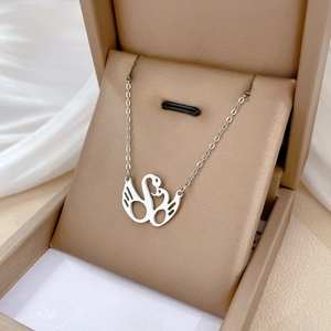 Minimalist silver swan necklace in premium jewelry box with elegant silk background
