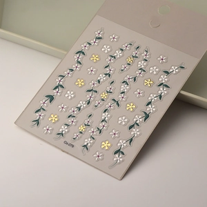 Macro detail of 5D floral nail art sticker Co-279 with gold accents and white petals