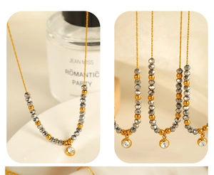 Detail of beaded necklace with gray crystals, gold beads and a sparkling zircon pendant