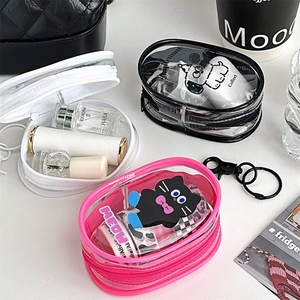Flat lay of colorful oval transparent PVC pouches for organizing travel accessories