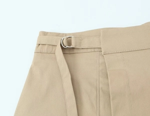 Macro detail of khaki cargo skirt waistband with adjustable silver D-ring buckle