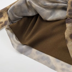 Close-up of leopard print mesh fabric with brown lining detail and fine mesh texture