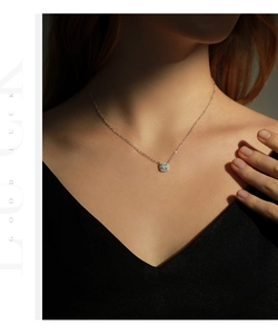 Close-up of s925 sterling silver square moissanite necklace worn on a model neckline