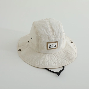 Detail of off-white quick-dry sun hat with adjustable wind rope and bear embroidery patch