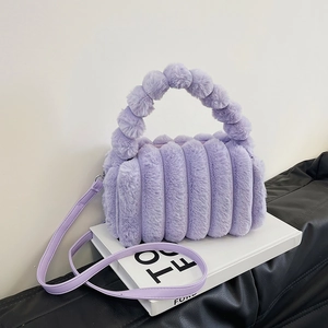 Purple plush tote bag with vertical texture and furry top handle on a stylish background