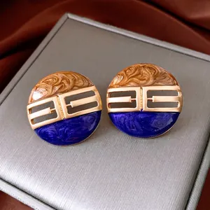 Vintage round enamel stud earrings with blue and brown marble pattern in gold frame