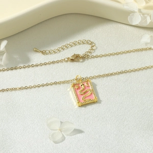 Detail of 18k gold-plated tarot snake pendant with pink enamel and sparkling crystals