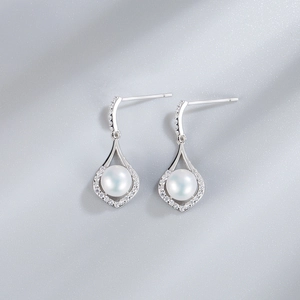 Close-up of S925 silver water drop earrings with white pearls and sparkling zirconia