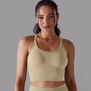 Detail of light beige seamless sports bra showing wide ribbed hem and elastic knit fabric