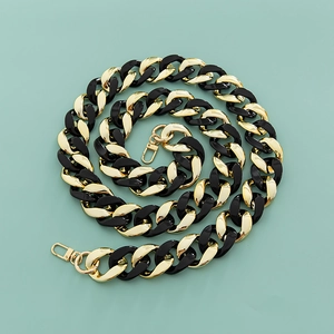 Macro view of black and gold chunky acrylic resin chain strap with spring metal buckles