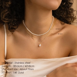 Double-layer 14K gold stainless steel necklace with pearl pendant on a model