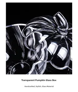 Macro detail of a handcrafted clear glass pumpkin storage jar with lid on black background