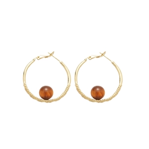 Golden round hoop earrings with twisted rope texture and amber resin beads