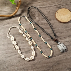 Three-piece ocean style necklace set with sea shells, beads, and white turtle pendant
