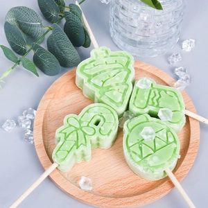 Christmas silicone ice cream molds with tree and sock shapes on a wooden tray