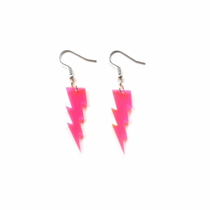 Detail of pink glitter lightning earrings in acrylic material on white background