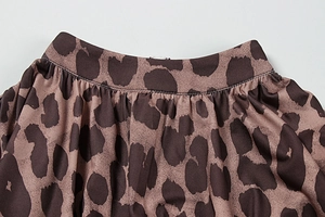 Detail of elastic pleated waist on leopard print chiffon dress with precise stitching