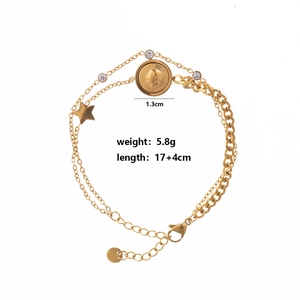 Detail of double-layer gold coin bracelet with star charm and sparkling crystals