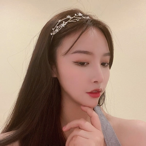 Detail of star-shaped headband with sparkling rhinestones and elegant pearls on model