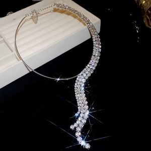 Macro shot of silver diamond-encrusted fringe choker necklace on a white gift box