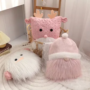 Christmas plush gnome pillows in pink and white set against cozy home holiday decor