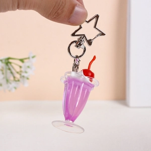 Handheld purple dessert cup keychain with cream topping and a star-shaped silver hook