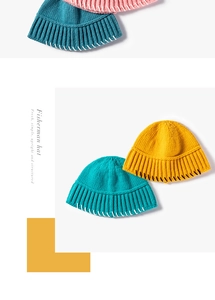 Detail of knitted fisherman hats in pink and blue with contrasting hand-stitched edges
