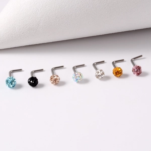 Macro detail of seven colorful crystal ball L-shaped stainless steel nose studs