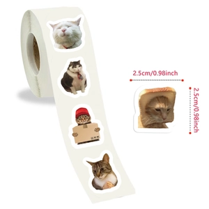 Detail of 2.5cm cat meme stickers on a roll for decorating journals and sealing envelopes