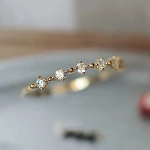 Macro shot of 18K gold-plated micro-pave cubic zirconia slim ring with 5 gems
