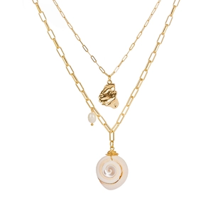 Detail of layered paperclip chain necklace with white pearl and spiral seashell pendant