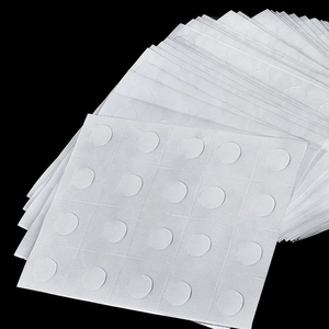 Macro view of white double-sided adhesive glue dots for balloon sealing and party decoration