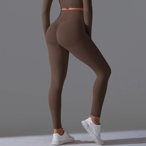 Detail view of high-waist dark coffee seamless yoga pants with butt-lifting texture