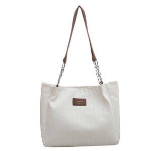 White quilted tote bag with brown straps and silver chain detail for summer commute