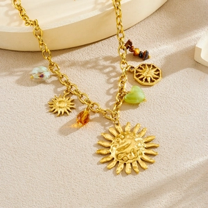 Chunky gold sun face pendant necklace with green heart bead and tiger eye stones