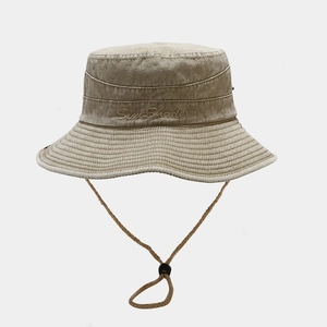 Detail of khaki washed cotton bucket hat featuring Sun Shade embroidery and windproof cord