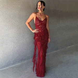 Detail of tiered lace ruffles and dark red fabric texture on a slim fit maxi dress