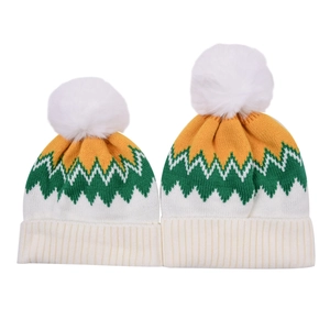 Detailed knit texture and fluffy white pom poms on yellow and green wavy patterned hats