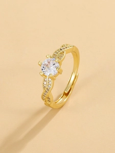 Detail view of the six-prong setting with a large round cubic zirconia on a gold ring