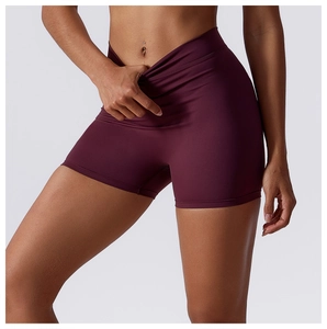 Detail of high-waist V-shaped tummy control and stretch fabric on burgundy yoga shorts