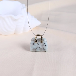 Miniature crystal stone handbag pendant with gold metal handle and grey spotted texture