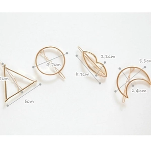 Set of minimalist gold geometric hair clips in circle, triangle, moon, and lip shapes