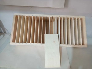 Detailed macro view showing a removable wooden divider being inserted into the display rack