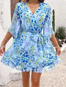 Close-up of blue floral chiffon dress with V-neckline and decorative ruffles