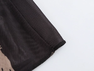 Close-up of black mesh fabric detail with fine grid structure and durable lockstitch seams