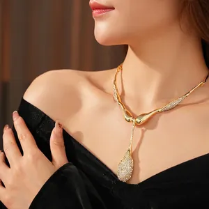 Elegant gold-tone irregular waterdrop pendant necklace with zircon stones on model