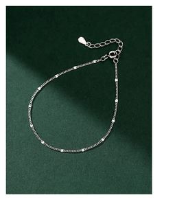 Detailed macro of S925 sterling silver chain featuring mini sequins and lobster clasp