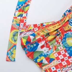 Detail of colorful Mediterranean print fabric with lemon and tile patterns on a halter neckline