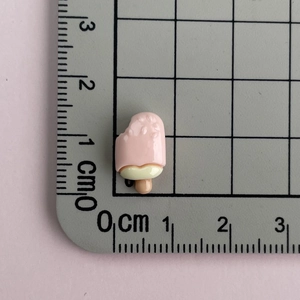 Detailed view of mini pink and yellow popsicle resin charms showing 1.5cm size measurement