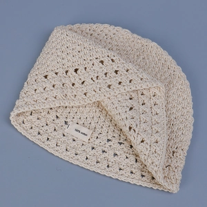 Handmade crochet cotton bucket hat in cream white featuring hollow knit texture